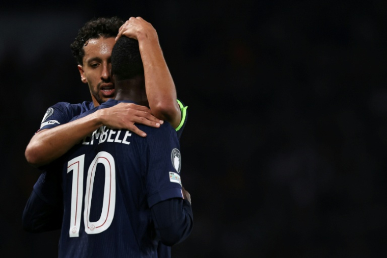 Le capitaine du Paris SG  Marquinhos (G) réconforte Ousmane Dembélé après sa blessure lors de la défaite face au Bayern Munich 2-1 en Ligue des champions, le 4 novembre 2025 au Parc des Princes ( AFP / Anne-Christine POUJOULAT )