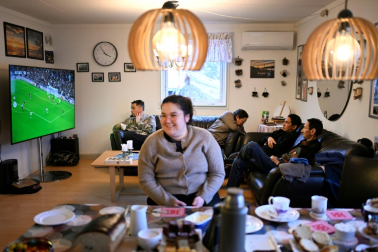La famille de Dorthe Olsen regarde un match de foot à la télé chez eux dans le hameau de Sarfannguit, près de Sisimiut, au Groenland, le 1er février 2026 ( AFP / Ina FASSBENDER )