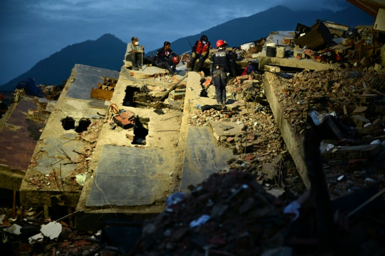 Des secouristes travaillent dans les ruines d'un immeuble effondré après le double séisme au Venezuela, le 3 juillet 2026 à Caraballeda, dans l’État de La Guaira  ( AFP / MARTIN BERNETTI )
