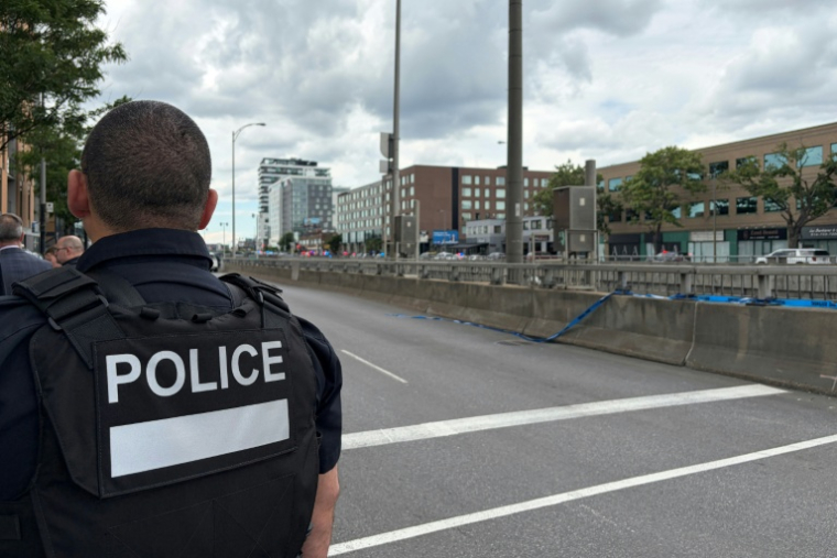 Un policier dans le quartier de Côte-des-Neiges, à Montréal, après une fusillade ayant fait trois morts, dont le suspect, le 22 juin 2026 au Canada ( AFP / Daphné LEMELIN )