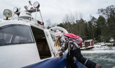 Une écolière embarque à bord d'un aéroglisseur pour rentrer de l'école, le 3 mars 2026 à Paragas, en Finlande ( AFP / Alessandro RAMPAZZO )