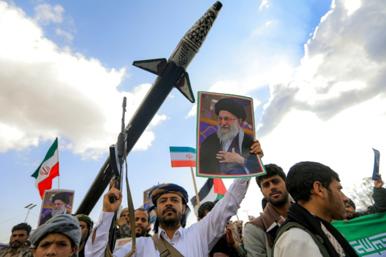 Un homme brandit une photo du guide suprême iranien Ali Khamenei lors d'un rassemblement à son hommage au Yémen, le 1er mars 2026 ( AFP / Mohammed HUWAIS )