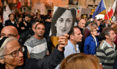People hold placards and photos of killed journalist Daphne Caruana Galizia during a protest called for by Galizia's family and civic movements on December 3, 2019 outside the police headquarters in Valletta. The scandal-dogged probe into the murder of investigative reporter Daphne Caruana Galizia has damaged relations between Malta and the EU, the head of a European Parliament fact-finding delegation said on December 3. The urgent mission of seven MEPs to the Mediterranean island follows an escalation in the murder case and Prime Minister Joseph Muscat's decision to resign over what critics have called a botched investigation. ( AFP / ANDREAS SOLARO )