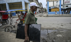 Un homme transporte un écran de télévision , dans une rue de La Havane, le 11 juillet 2026 ( AFP / YAMIL LAGE )