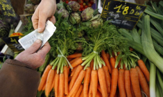 Un client achète des légumes sur un marché à Nice