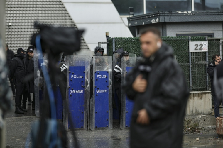 Des policiers antiémeutes turcs interdisent l'accès à l'immeuble hébergeant le siège de la chaîne d'opposition Halk TV, à Istanbul, le 14 octobre 2026 ( AFP / BERK OZKAN )