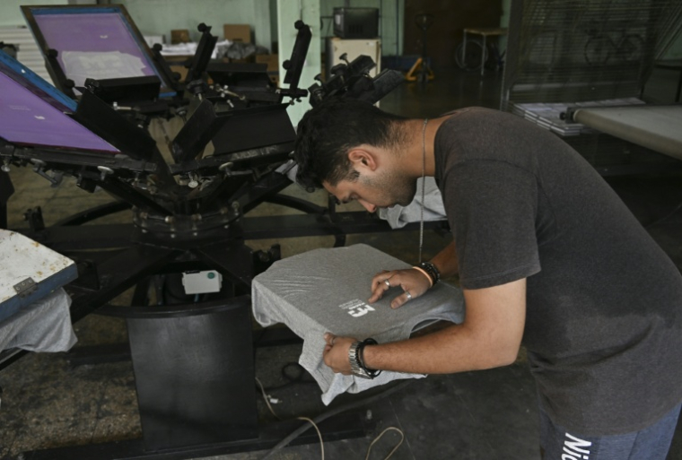 Un technicien travaille dans une petite entreprise privée de sérigraphie à La Havane, le 22 juin 2026 ( AFP / YAMIL LAGE )