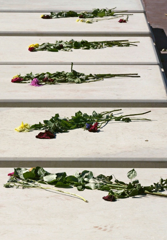 Des fleurs sont déposées sur des tombes, le 4 septembre 2003 au cimetière parisien de Thiais où cinquante-sept personnes âgées, décédées lors de la canicule et dont les corps n'ont pas été réclamés, ont été inhumées, dans le Val-de-Marne ( AFP / DANIEL JANIN )