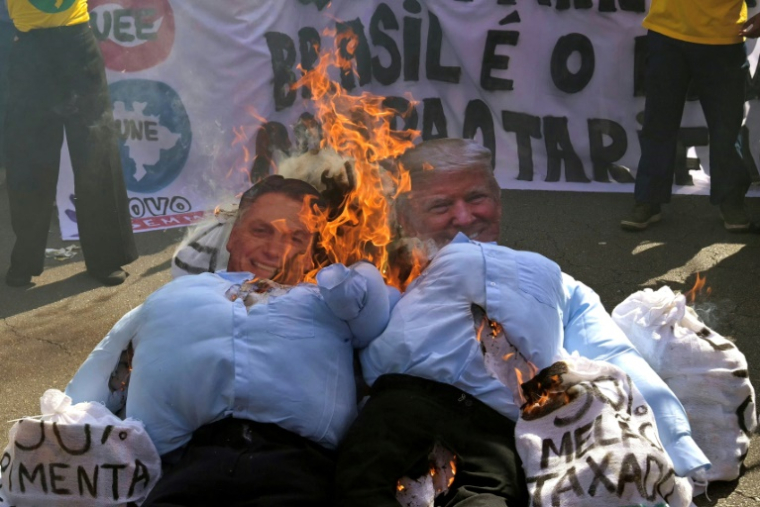 Des effigies du président américain Donald Trump et de l'ex-président brésilien Jair Bolsonaro sont brûlées, le 1er août 2025 à Sao Paulo lors d'une manifestation ( AFP / Nelson ALMEIDA )