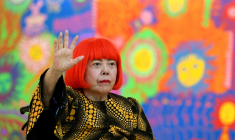 L'artiste japonaise Yayoi Kusama salue lors d’une séance photo pendant la préouverture presse de son exposition intitulée "Mon âme éternelle" au National Art Center de Tokyo, le 21 février 2017 ( AFP / TOSHIFUMI KITAMURA )