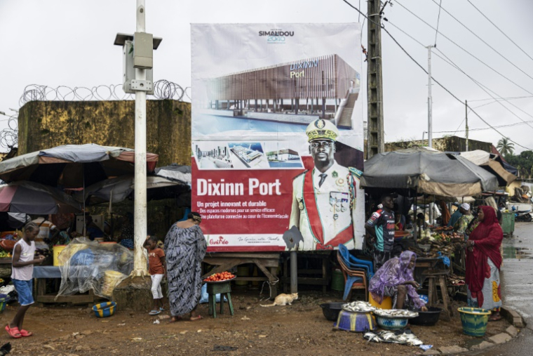 Un portrait du président guinéen Mamadi Doumbouya sur un panneau d'affichage sur un marché à Conakry, le 7 septembre 2025, avant le référendum constitutionnel du 21 septembre 2025 ( AFP / PATRICK MEINHARDT )