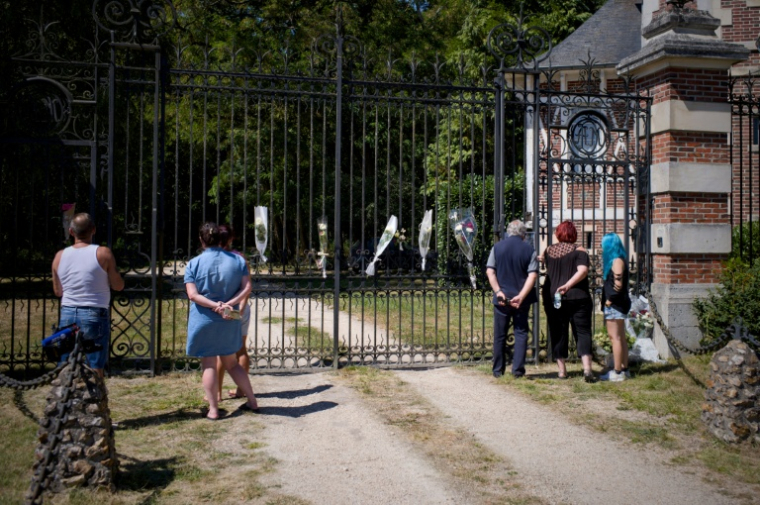 Des gens déposent des fleurs à l'entrée de la propriété de Delon, La Brulerie à Douchy, dans le centre de la France, le 18 août 2025 ( AFP / GUILLAUME SOUVANT )
