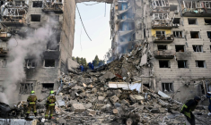 Des sauveteurs ukrainiens dans les décombres d'un immeuble résidentiel gravement endommagé par une frappe de missiles russes, le 17 juin 2025 à Kiev ( AFP / Genya SAVILOV )