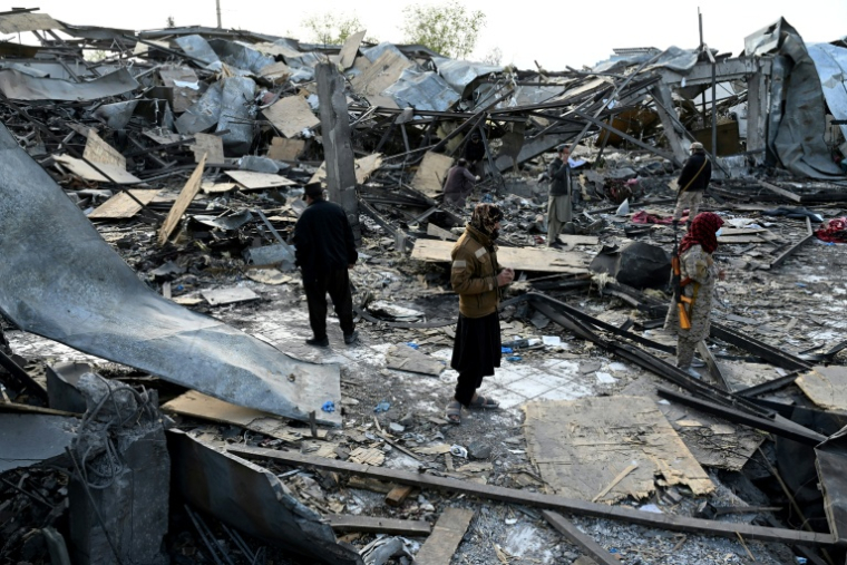 Des membres des forces de sécurité talibanes dans les décombres d'un hôpital pour toxicomanes après des frappes aériennes pakistanaises, le 17 mars 2026 à Kaboul, en Afghanistan ( AFP / Wakil KOHSAR )