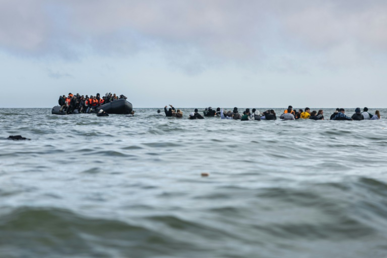 Des migrants embarquent à bord d'un bateau pour tenter de traverser la Manche, le 26 mars 2025 au large de la plage de Gravelines, dans le nord de la France ( AFP / Sameer Al-DOUMY )