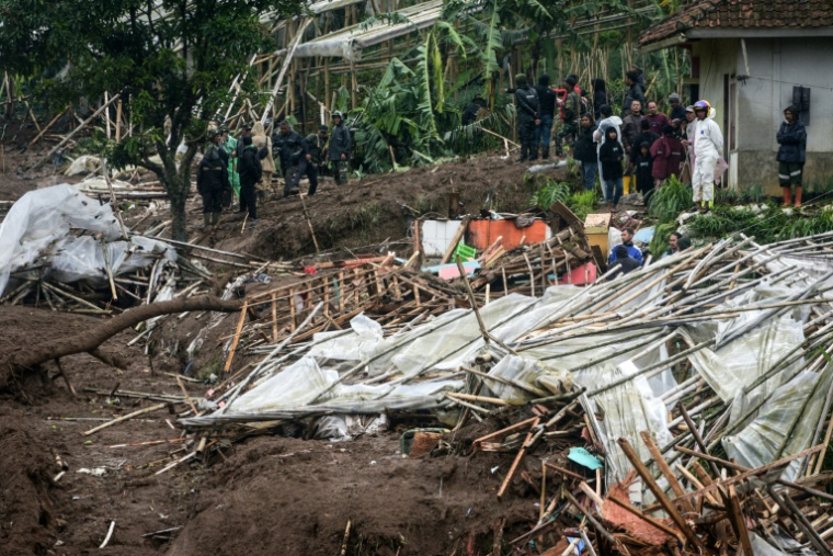 Des secouristes à la recherche de victimes après un glissement de terrain dans le village de Pasirlangu, dans la région du Bandung occidental, au sud-est de Jakarta, le 24 janvier 2026 ( AFP / Timur Matahari )