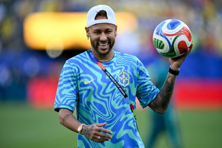 Neymar sourit aux photographes pendant l'échauffement de ses coéquipiers brésiliens le 13 juin avant leur match contre le Maroc. ( AFP / Mauro PIMENTEL )
