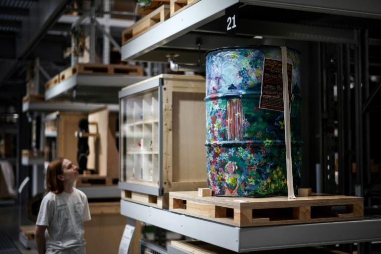 Une visiteuse regarde les oeuvres d'art exposées à la Storehouse du Victoria et Albert Museum, dans l'est de Londres, le 12 juin 2025 ( AFP / HENRY NICHOLLS )