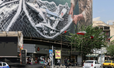 Des véhicules passent devant un immense panneau d'affichage sur lequel est écrit "Le détroit d'Ormuz reste fermé", sur la place de la Révolution à Téhéran, le 28 avril 2026, en Iran ( AFP / ATTA KENARE )