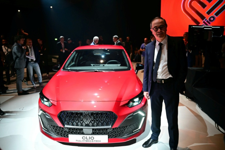 Le DG de Renault François Provost au Salon automobile de Munich le 8 septembre 2025, posant à côté de la nouvelle Clio "full hybrid e-tech" ( AFP / Tobias SCHWARZ )
