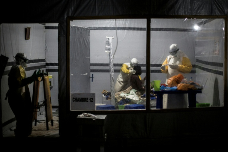 Des personnels de santé soignent un patient dans un centre de traitement Ebola (CTE) soutenu par MSF, le 3 novembre 2018 à Butembo, en RDC ( AFP / John WESSELS )