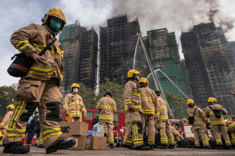 Des pompiers se préparent après qu'un important incendie a ravagé plusieurs immeubles d'appartements du complexe résidentiel Wang Fuk Court à Hong Kong, le 27 novembre 2025 ( AFP / Dale DE LA REY )