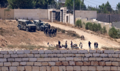 Des soldats israéliens face à des colons assiégeant des maissons palestiniennes du village de Qusra, en Cisjordanie occupée, le 12 août 2026 ( AFP / Zain JAAFAR )
