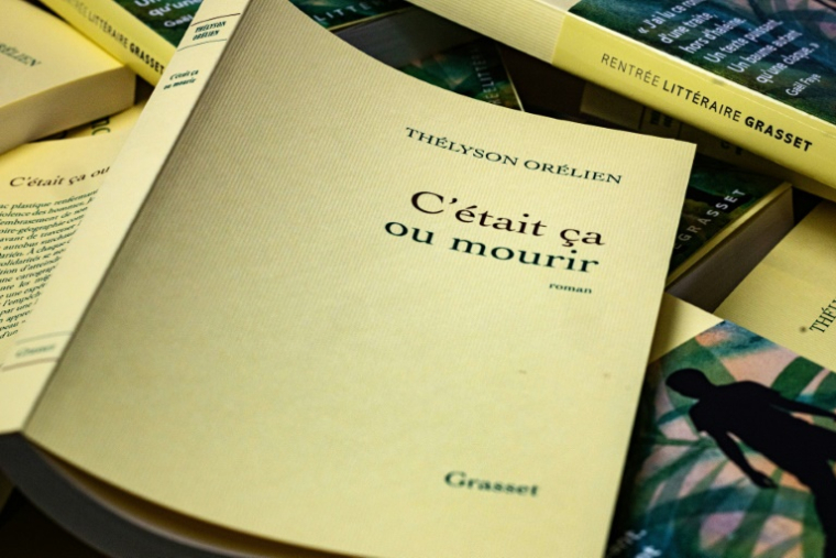 Des exemplaires du livre "C'était ça ou mourir", écrit par le romancier haïtien-canadien Thelyson Orelien, en marge de la 28e édition d'un festival littéraire à Manosque, dans le sud-est de la France, le 24 septembre 2026 ( AFP / Joel Saget )