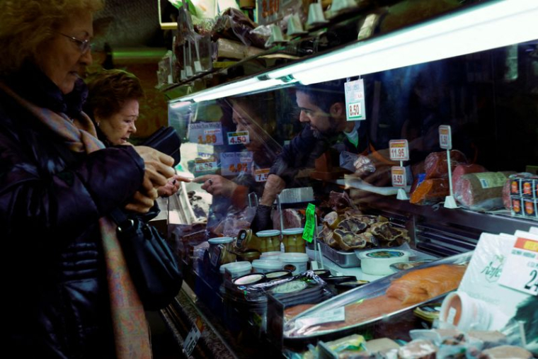 Customers shop in a supermarket as the Spanish government announces measures to battle inflation in Madrid
