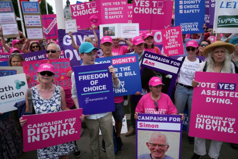Des militants en faveur d'une modification de la loi sur l'aide médicale à mourir pour les personnes en phase terminale manifestent devant le palais de Westminster, siège du Parlement, le 16 mai 2025 à Londres ( AFP / CARLOS JASSO )