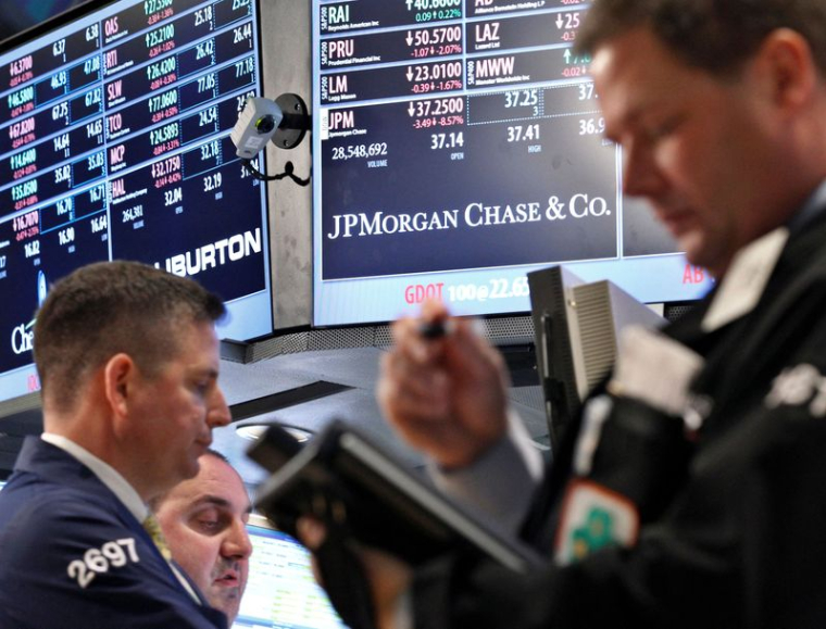 Des traders travaillent au poste de négociation de JP Morgan sur le parquet de la Bourse de New York