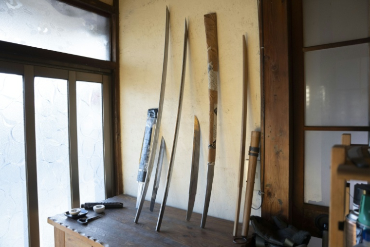 Des lames de katana appuyées contre un mur dans l'atelier du forgeron Akihira Kawasaki à Misato, le 9 janvier 2026 au Japon ( AFP / Yuichi YAMAZAKI )