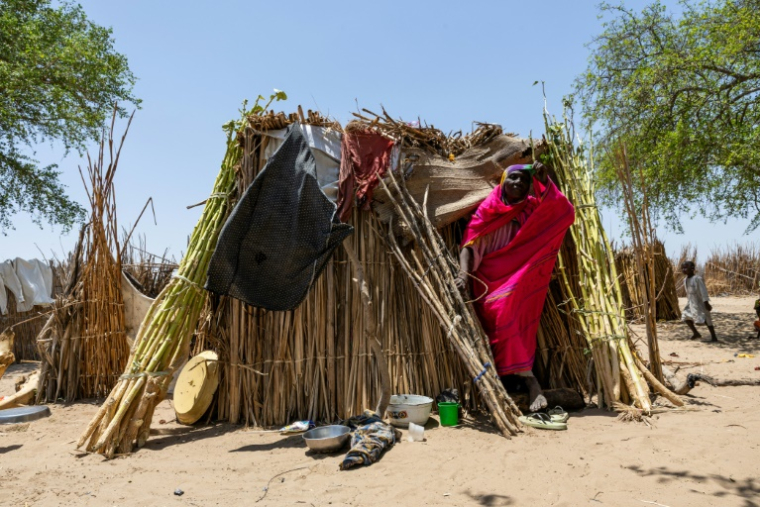 Baya Ali Moussa, 45 ans, sort de son abri, dans le camp de personnes déplacées de Yakoua, dans la province du lac Tchad, le 21 juin 2025 au Tchad ( AFP / Joris Bolomey )