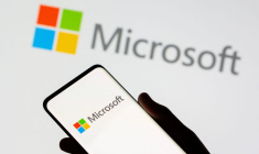 Un smartphone est vu devant le logo de Microsoft sur cette illustration