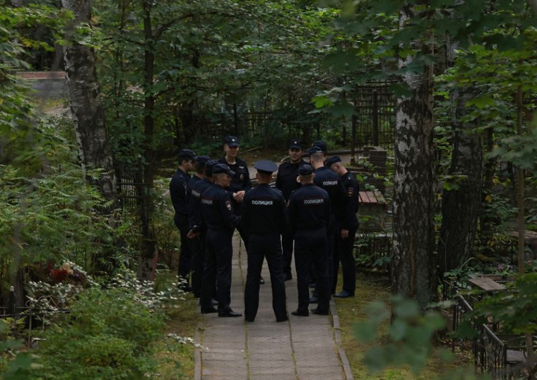 Des policiers se rassemblent près de la tombe d'Evgueni Prigojine au cimetière Porokhovskoye à Saint-Pétersbourg