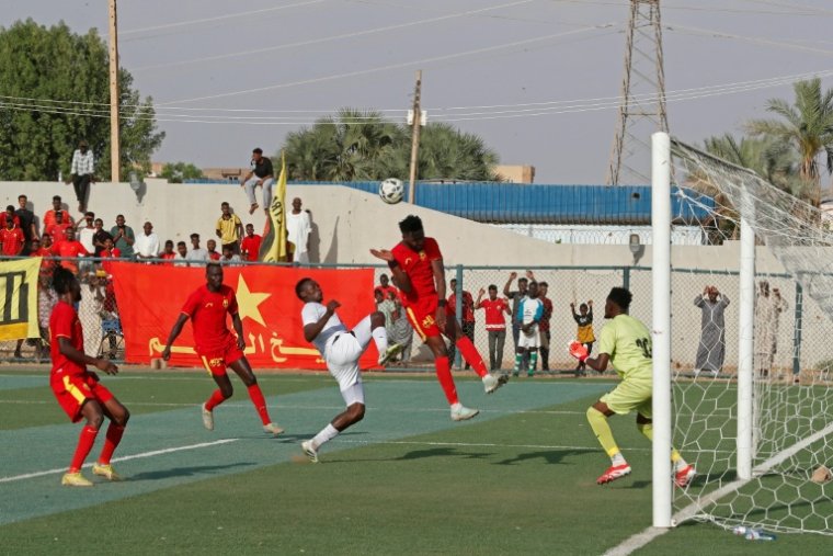Des joueurs du club Al Merrikh (en rouge) contre un de leurs adversaires de l'équipe d'Ahli Madani, lors du match d'ouverture du championnat soudanais, le 15 mai 2026 à Khartoum  ( AFP / Ebrahim Hamid )