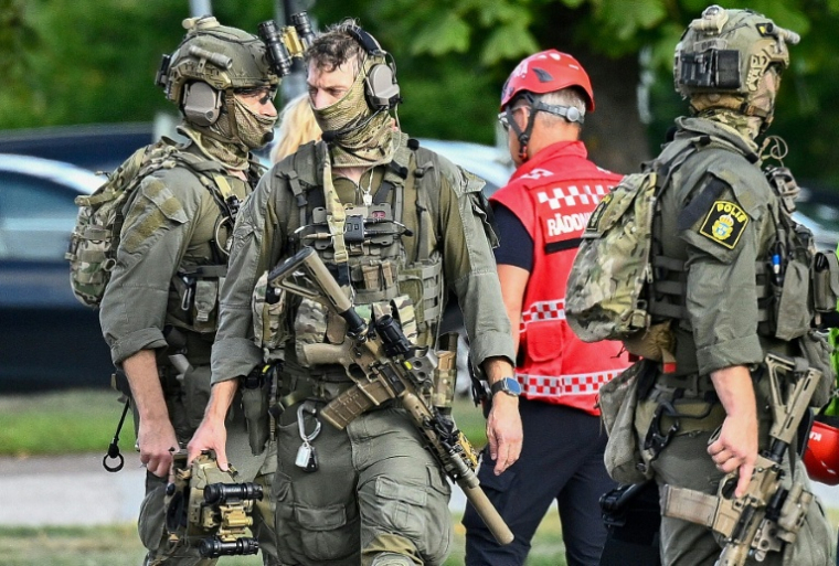 Des membres des forces spéciales de police sur les lieux où un agresseur armé d'une épée a blessé plusieurs personnes dans un lycée à Fagersta, dans le centre de la Suède, le 21 août 2026 ( TT NEWS AGENCY / Fredrik SANDBERG )
