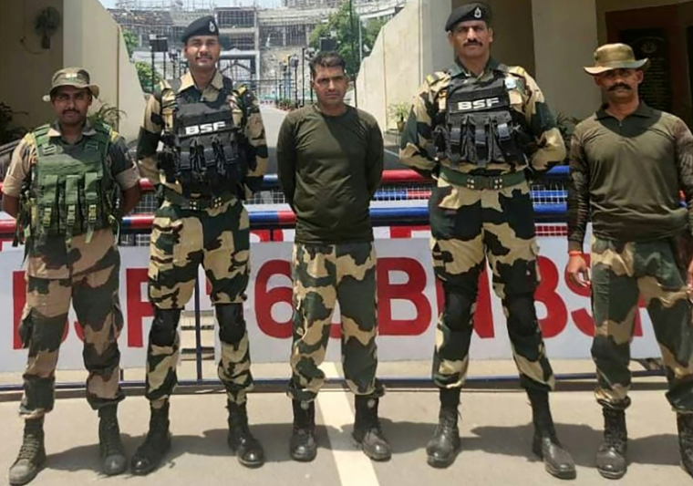 Photo prise et diffusée le 14 mai 2025 par la Force de sécurité des frontières indienne (BSF) montrant le soldat indien de la BSF, Purnam Kumar Shaw (c), après avoir été remis à l'Inde, au poste frontière indo-pakistanais de Wagah, près d'Amritsar ( Force de sécurité des frontières indienne (BSF) / - )