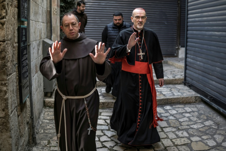 Le cardinal Pierbattista Pizzaballa (D), patriarche latin de Jérusalem, arrive accompagné de frères franciscains à l’église du Saint-Sépulcre pour célébrer la messe de Pâques, à huis clos en raison de la guerre, dans la vieille ville de Jérusalem, le 5 avril 2026 ( AFP / MARCO LONGARI )