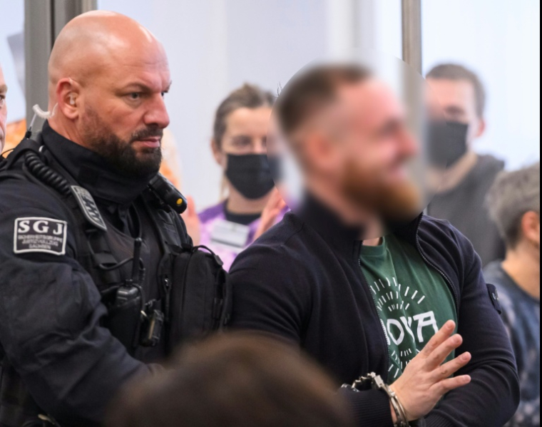 L'accusé Johann G. est amené devant le tribunal de Dresde au premier jour d'audience du procès du groupe Antifa Ost, le 25 novembre 2025 ( POOL / MATTHIAS RIETSCHEL )
