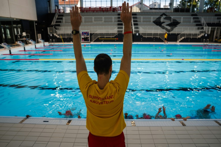 Un maître-nageur donne un cours lors d'un stage gratuit "Savoir nager", le 8 août 2025 au stade nautique Maurice Thorez de Montreuil, près de Paris ( AFP / Dimitar DILKOFF )