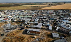 The shanty town spreads out between the disused runways of a former military airfield. ( AFP / Tiziana FABI )