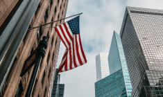 drapeau américain et building (Crédits: Unsplash - Nik Shuliahin)