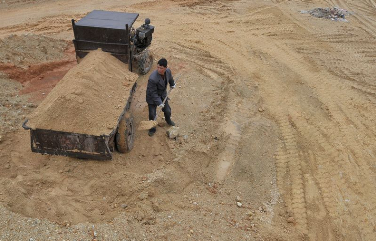 FILE PHOTO: A labourer works at a site of a rare earth metals mine at Nancheng county, Jiangxi province
