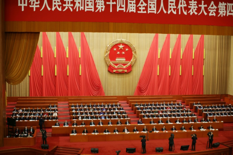 Des délégués assistent à la séance de clôture de l'Assemblée nationale populaire (ANP) au Palais du Peuple à Pékin le 12 mars 2026 ( POOL / ANDRES MARTINEZ CASARES )