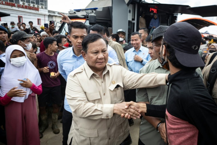 Prabowo Subianto (C) rencontre des personnes qui ont perdu leurs logements dans les récentes inondations à Aceh dans le nord de Sumatra en Indonésie le 12 décembre 2025  ( AFP / Aditya Aji )