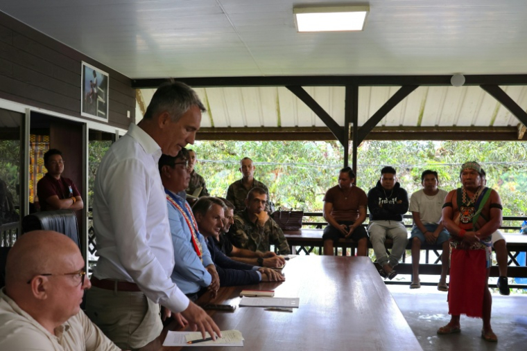 Le préfet de Guyane, Antoine Poussier (2e g) et côtés du maire de Camopi, Laurent Yawalou (3eg), lors d'une réunion avec des habitants de Camopi, ville frontalière du Brésil, où les habitants protestent contre les passages de la frontière par des orpailleurs illégaux, le 11 mai 2026 en Guyane ( AFP / Guillaume REUGE )