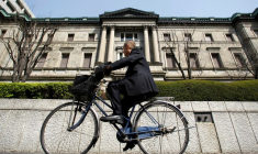 Photo d'archive d'un homme à vélo passant devant le bâtiment de la BOJ à Tokyo