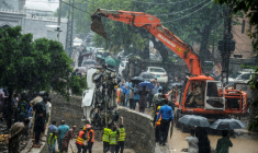 RDes sauveteurs et des habitants autour d'une grue retirant l'épave d'une camionnette après de fortes pluies de mousson à Islamabad, le 21 juillet 2025 au Pakistan ( AFP / M ASIM KHAN )