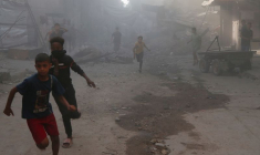 Palestinians inspect the site of an Israeli air strike on a house in Gaza City